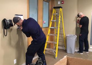 Maintenance Technicians Jeff Vogt and Matt Litzenberger carrying out essential electrical work at UBCO
