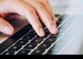 Fingers on computer keyboard