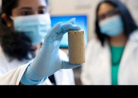 UBCO postdoctoral research fellow Chinchu Cherian, along with Associate Professor Sumi Siddiqua, examines a road-building material created partly with recycled wood ash.