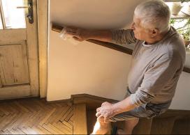 Older man using handrail