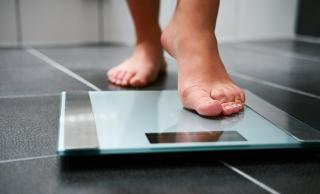 Person stepping onto weight scale