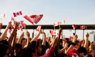 Group waving Canada flags